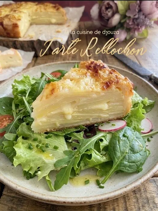 Part de tarte au reblochon servie avec salade verte